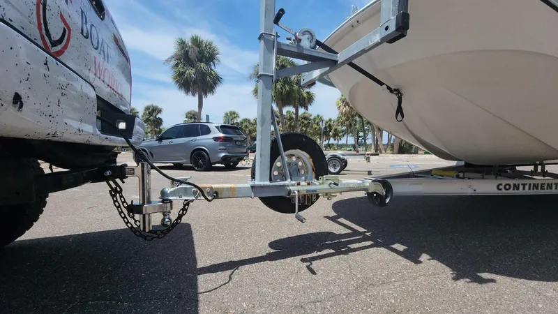 Slide: The Image of Trailer hitch connecting a 2011 Carolina Skiff 178 DLV boat in a sunny parking lot. - 41