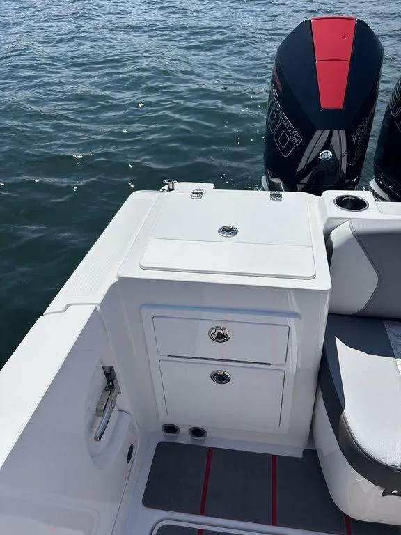 Slide: The Image of 2024 Fountain 32 NX boat with dual outboard engines on the water. - 11