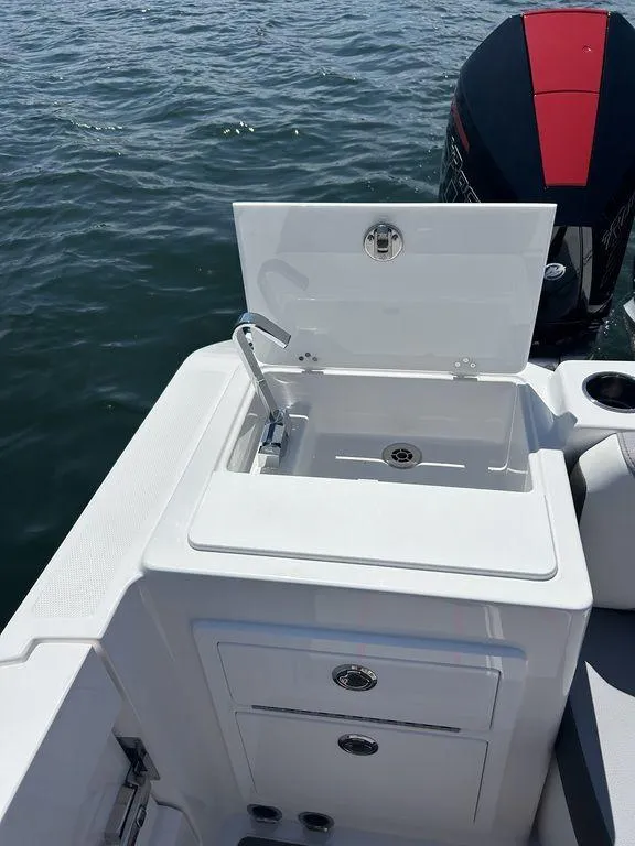Slide: The Image of 2024 Fountain 32 NX boat with open sink and storage compartments. - 15