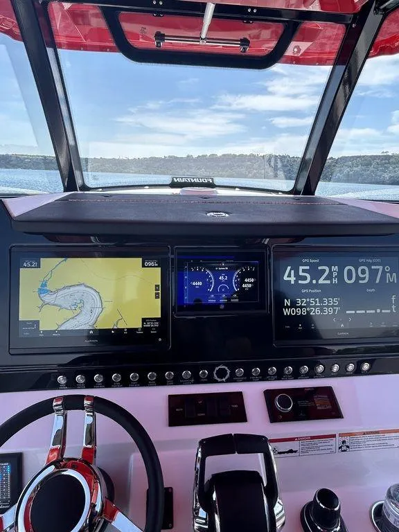 Slide: The Image of 2024 Fountain 32 NX boat dashboard with navigation and speed displays. - 17