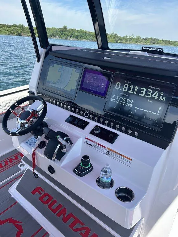 Slide: The Image of Control console of a 2024 Fountain 32 NX boat with advanced navigation displays. - 20
