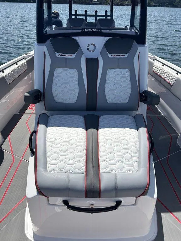 Slide: The Image of 2024 Fountain 32 NX boat with luxurious seating on a calm lake. - 7