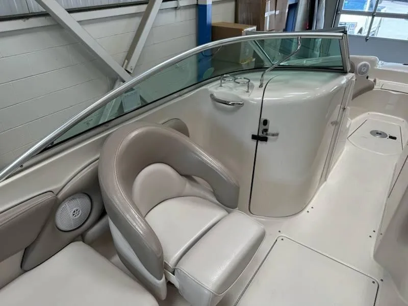 Slide: The Image of 2004 Sea Ray 240 Sundeck interior with seating and windshield. - 10