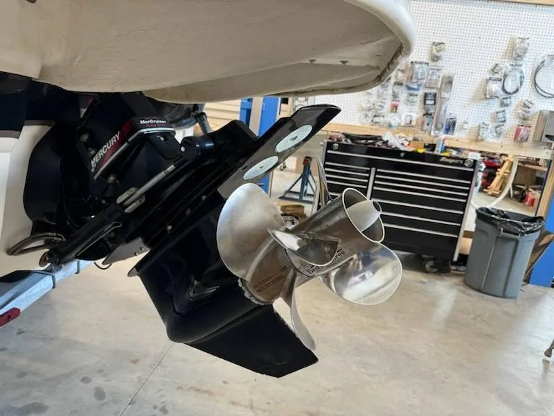 Slide: The Image of Close-up of 2004 Sea Ray 240 Sundeck's MerCruiser outdrive in a workshop. - 12