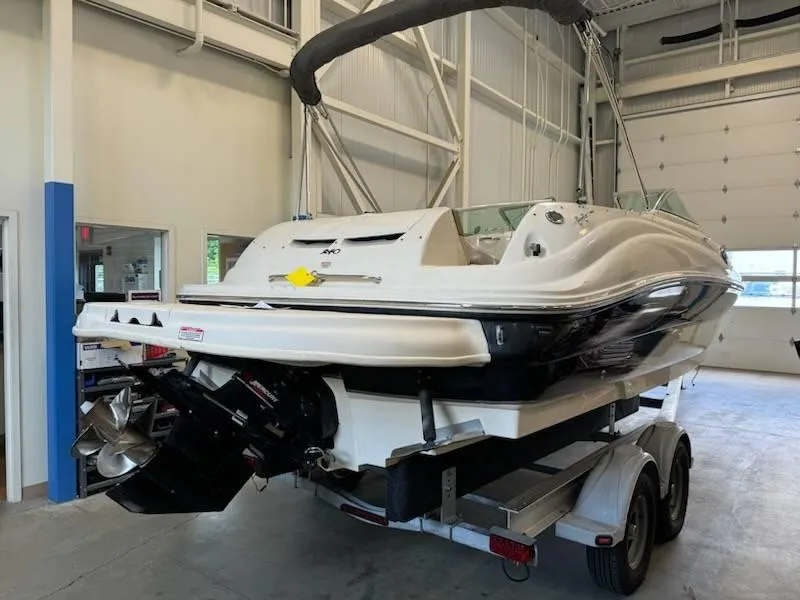 Slide: The Image of 2004 Sea Ray 240 Sundeck boat on a trailer in a storage facility. - 3