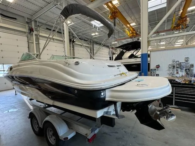 Slide: The Image of 2004 Sea Ray 240 Sundeck boat on trailer in indoor storage facility. - 4
