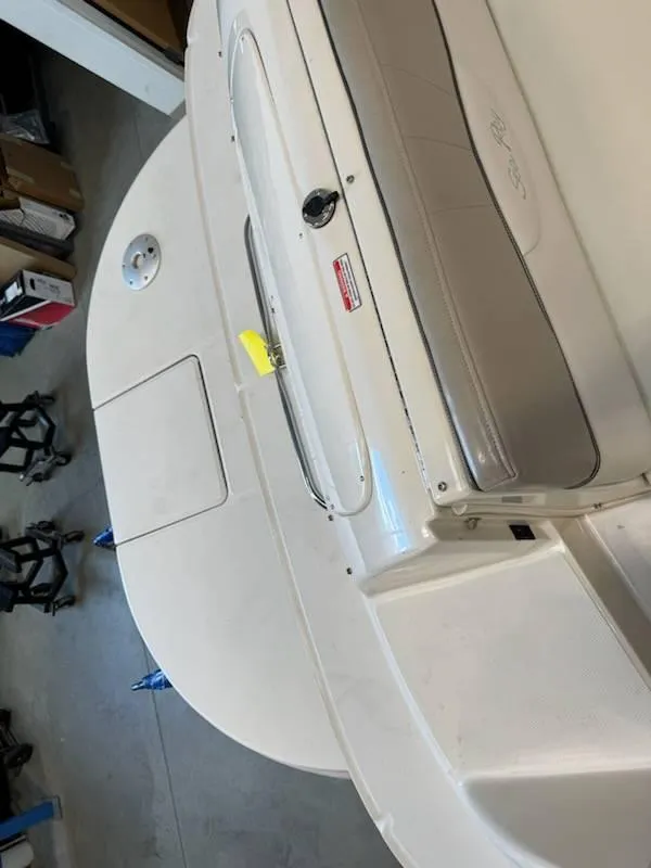 Slide: The Image of 2004 Sea Ray 240 Sundeck boat interior, featuring seating and storage compartments. - 5