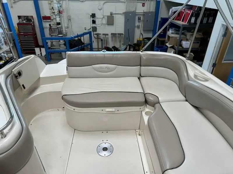 Slide: The Image of 2004 Sea Ray 240 Sundeck interior seating area in a workshop. - 7