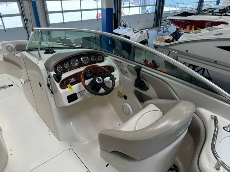 Slide: The Image of 2004 Sea Ray 240 Sundeck boat interior with steering wheel and dashboard. - 8