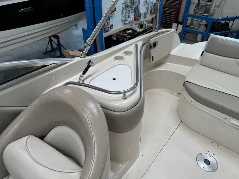 Slide: The Image of Interior of a 2004 Sea Ray 240 Sundeck boat with seating and cup holders. - 9