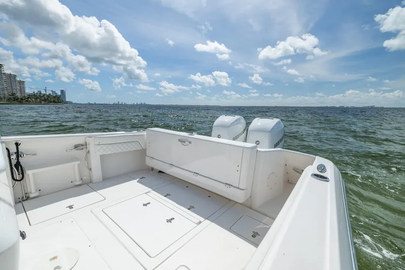Slide: The Image of 2019 Intrepid 327 Center Console boat on open water under a clear sky. - 12