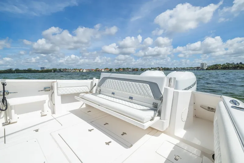 Slide: The Image of 2019 Intrepid 327 Center Console boat with white seating and ocean view. - 13
