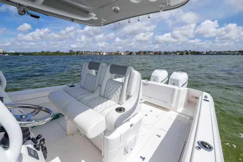 Slide: The Image of 2019 Intrepid 327 Center Console boat on water with luxury seating and twin engines. - 14