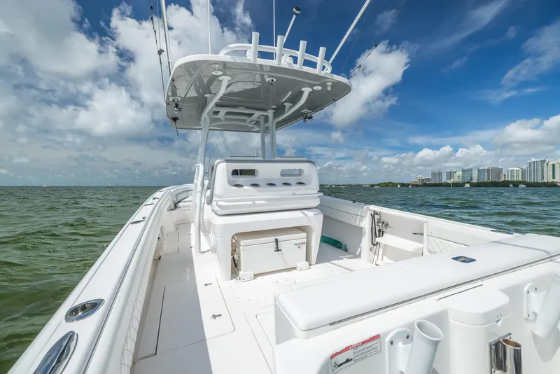 Slide: The Image of 2019 Intrepid 327 Center Console boat on open water with city skyline in background. - 15