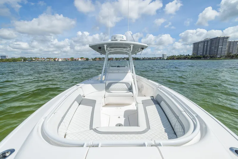 Slide: The Image of 2019 Intrepid 327 Center Console boat on water with cityscape background. - 16