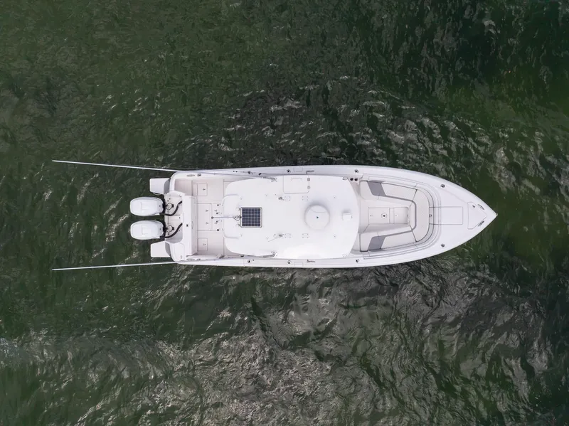 Slide: The Image of Aerial view of a 2019 Intrepid 327 Center Console boat on water. - 2