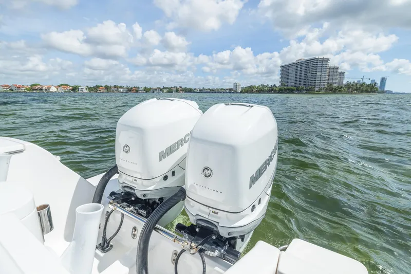 Slide: The Image of 2019 Intrepid 327 Center Console with twin Mercury outboard engines on the water. - 22