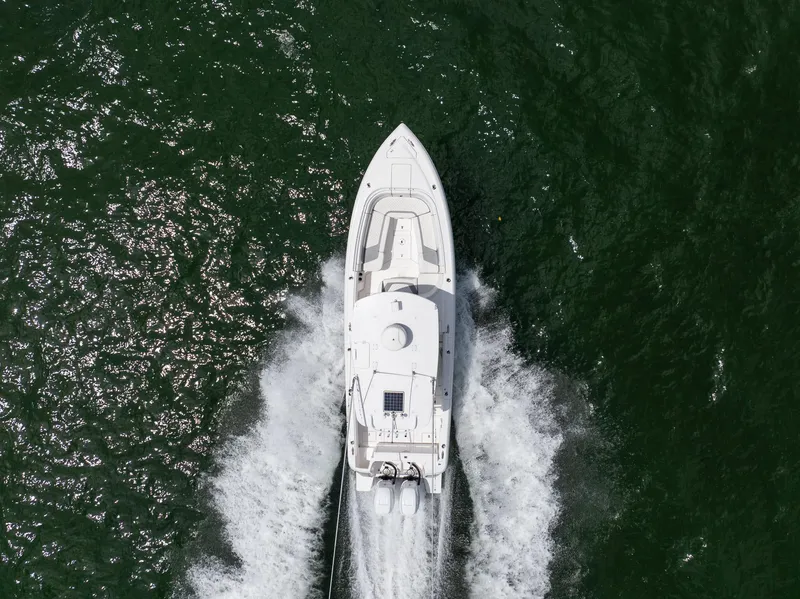 Slide: The Image of Aerial view of a 2019 Intrepid 327 Center Console boat cruising on water. - 23