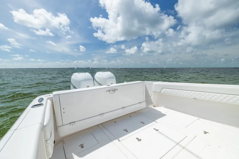 Slide: The Image of 2019 Intrepid 327 Center Console boat on open water under a blue sky. - 26