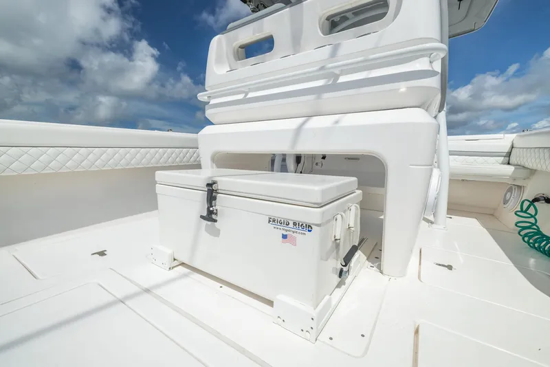 Slide: The Image of 2019 Intrepid 327 Center Console boat deck with cooler and seating. - 3