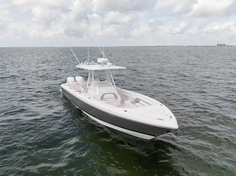 Slide: The Image of 2019 Intrepid 327 Center Console boat on open water under cloudy sky. - 31