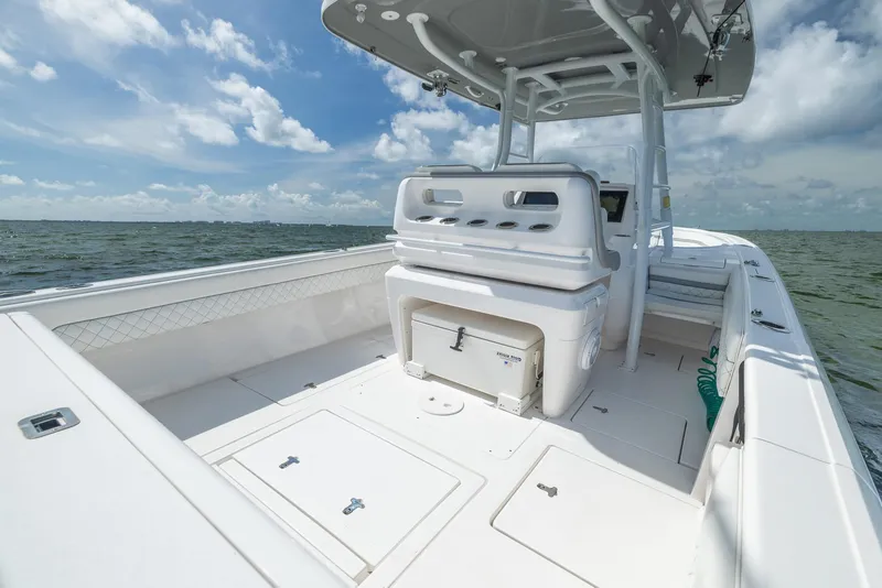 Slide: The Image of 2019 Intrepid 327 Center Console boat on open water under blue sky. - 32