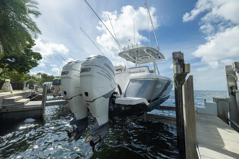 Slide: The Image of 2019 Intrepid 327 Center Console boat with twin outboard engines docked. - 34