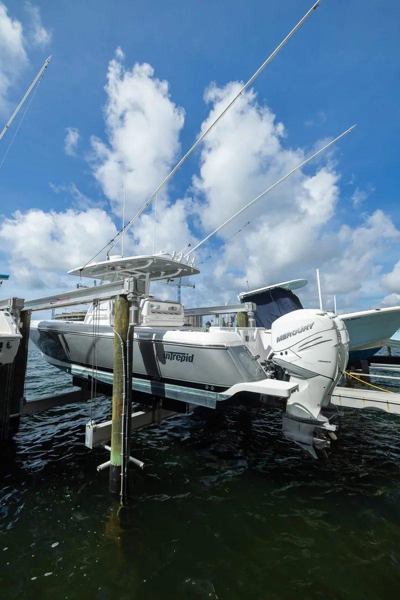 Slide: The Image of 2019 Intrepid 327 Center Console boat docked with Mercury outboard engines. - 37