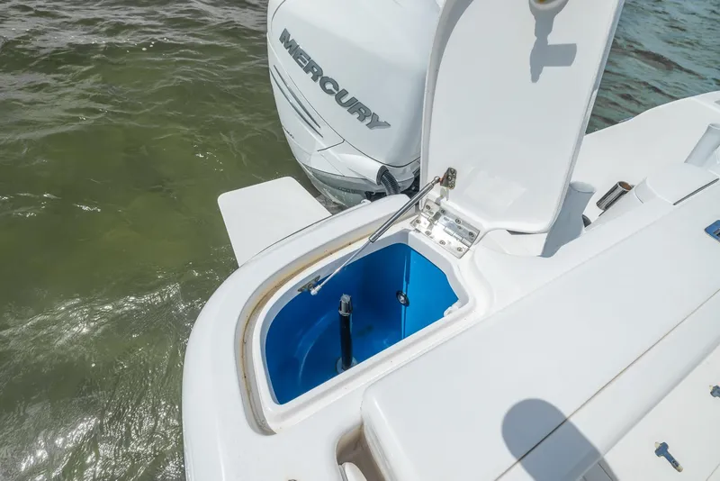 Slide: The Image of 2019 Intrepid 327 Center Console boat with open storage compartment and Mercury engine. - 41