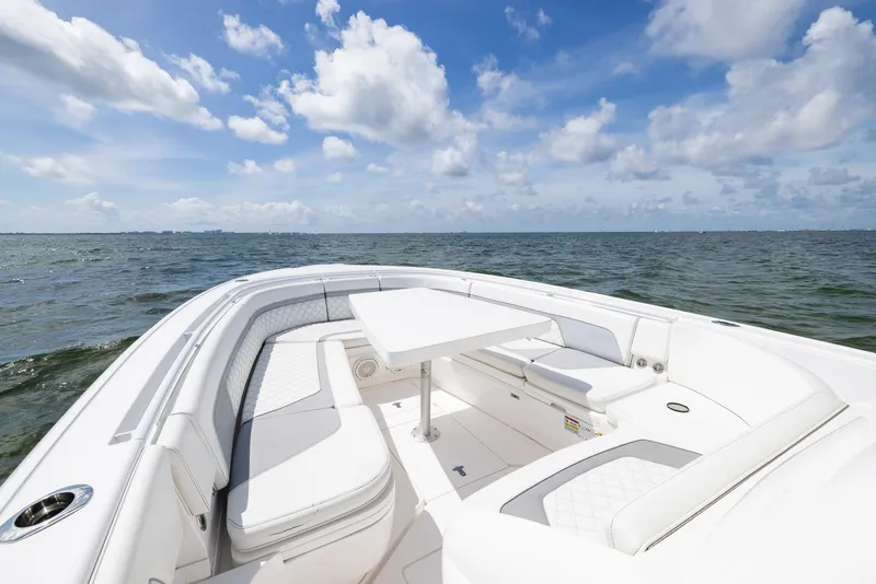 Slide: The Image of 2019 Intrepid 327 Center Console boat with spacious seating and table on open water. - 46