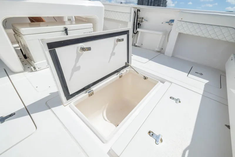 Slide: The Image of 2019 Intrepid 327 Center Console boat with open storage compartment. - 47