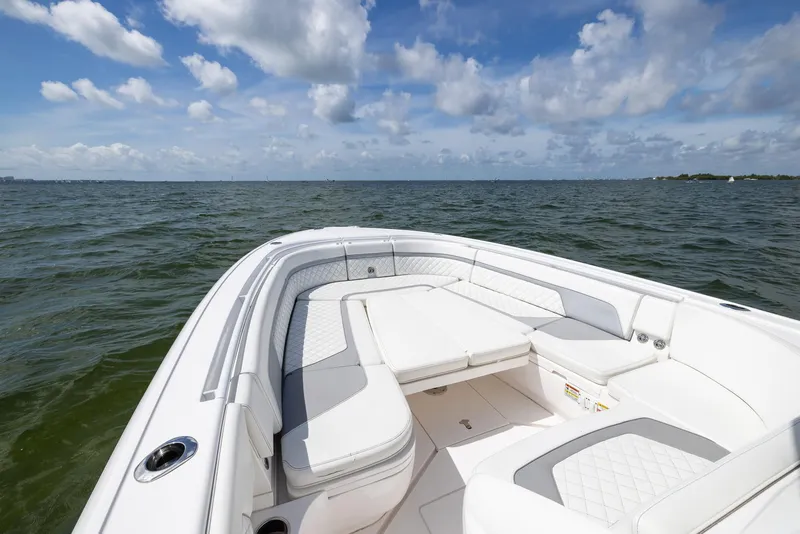 Slide: The Image of 2019 Intrepid 327 Center Console boat on open water under a blue sky. - 48