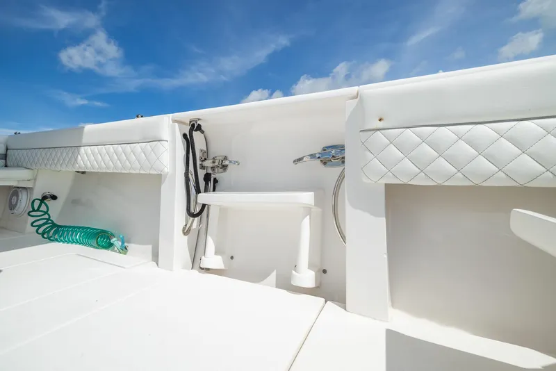 Slide: The Image of 2019 Intrepid 327 Center Console boat interior with white seating and blue sky background. - 7
