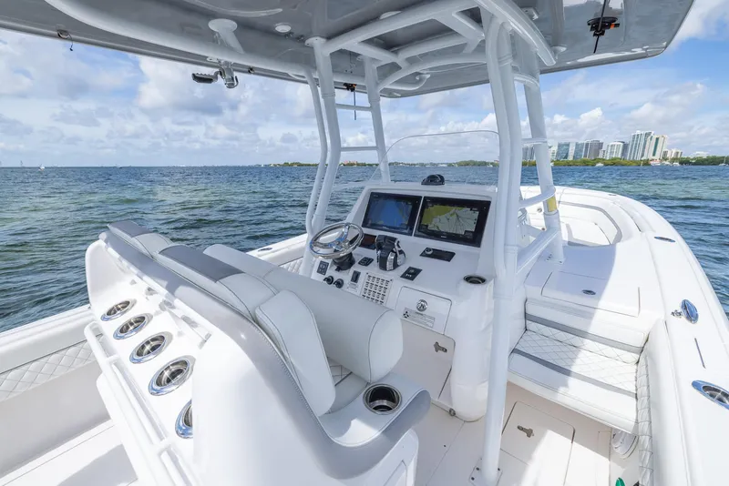 Slide: The Image of 2019 Intrepid 327 Center Console boat interior with navigation system and seating. - 9