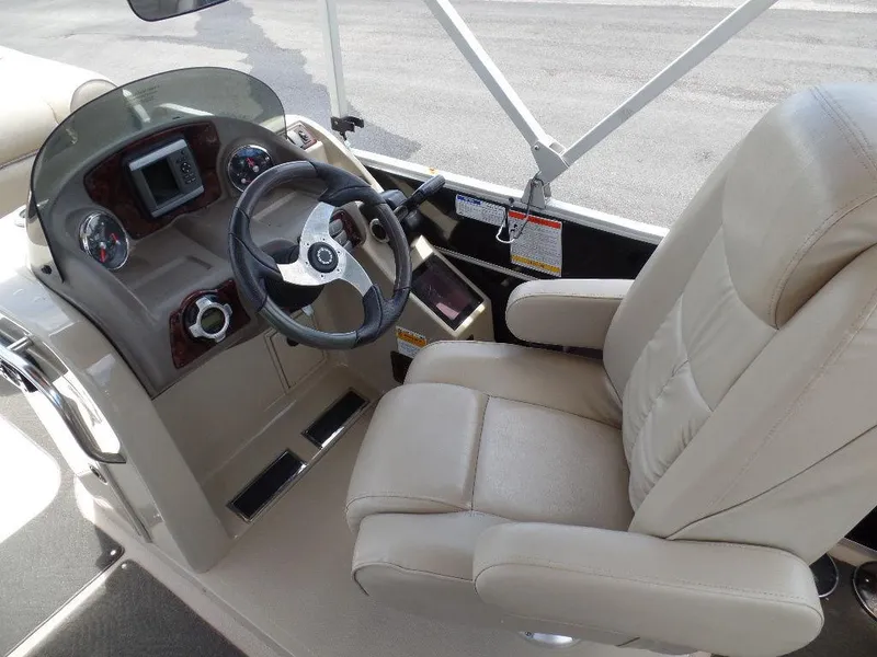 Slide: The Image of 2013 SunCatcher Elite 326 SS boat cockpit with steering wheel and captain's chair. - 11