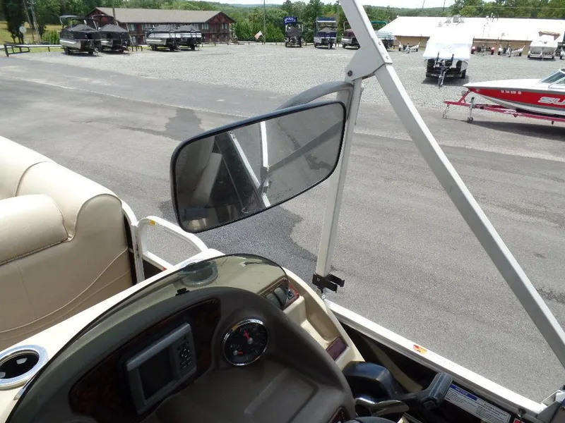 Slide: The Image of 2013 SunCatcher Elite 326 SS boat interior with dashboard and rearview mirror. - 13