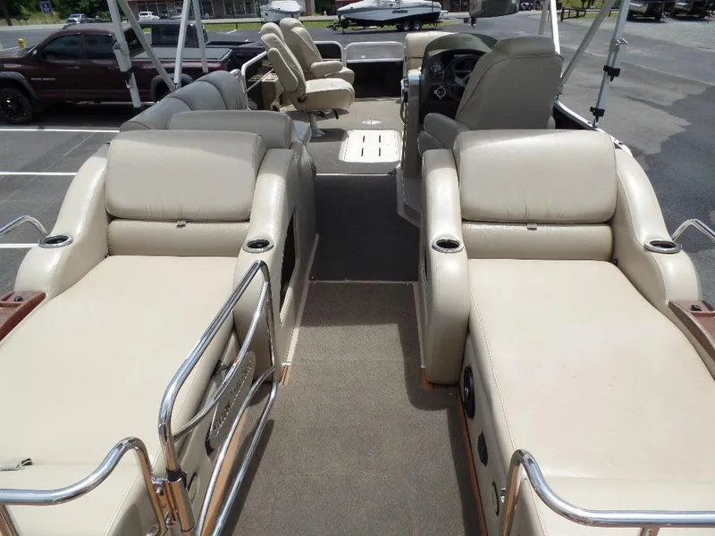 Slide: The Image of 2013 SunCatcher Elite 326 SS boat interior with beige seating and steering console. - 17