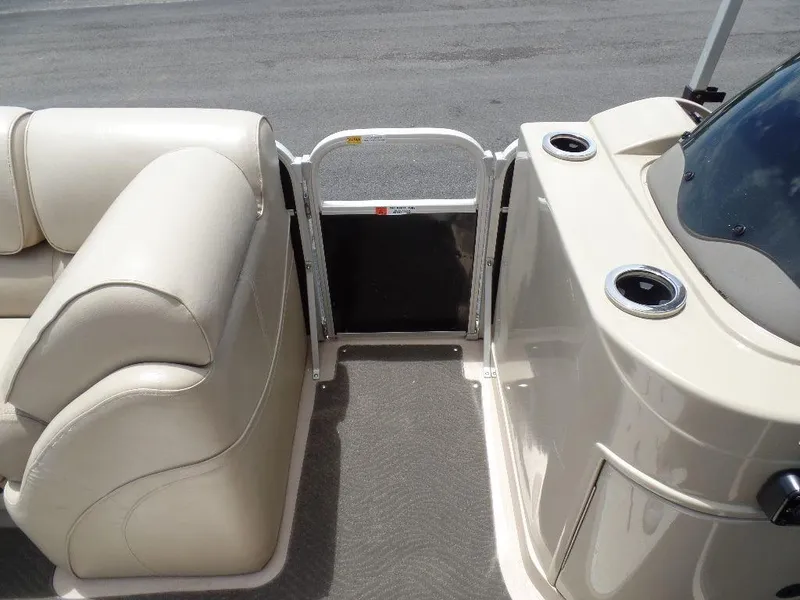 Slide: The Image of 2013 SunCatcher Elite 326 SS boat interior with beige seating and cup holders. - 19
