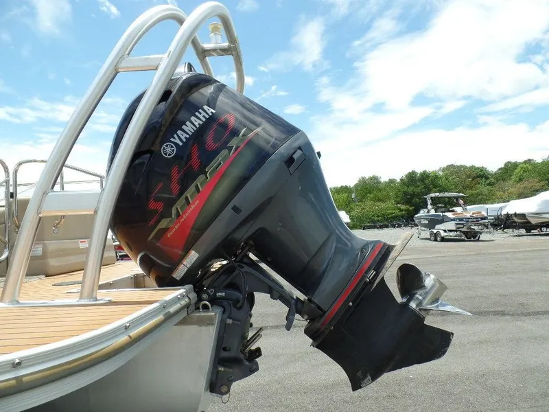 Slide: The Image of 2013 SunCatcher Elite 326 SS with Yamaha outboard motor in a marina. - 2