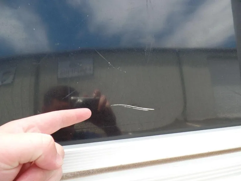 Slide: The Image of Close-up of a scratch on a 2013 SunCatcher Elite 326 SS window. - 22
