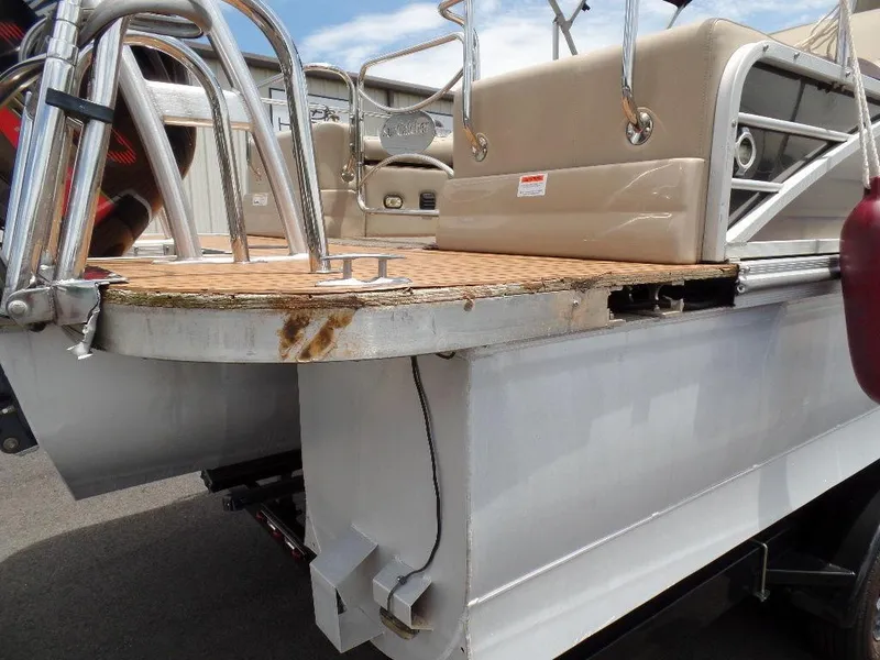 Slide: The Image of 2013 SunCatcher Elite 326 SS pontoon boat with visible wear and rust on the deck edge. - 24