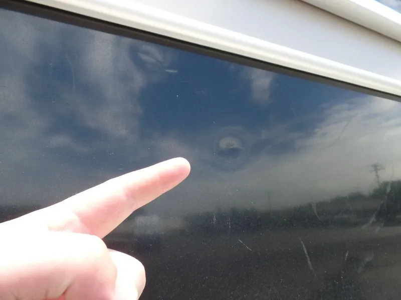 Slide: The Image of Close-up of a dent on a 2013 SunCatcher Elite 326 SS boat. - 25