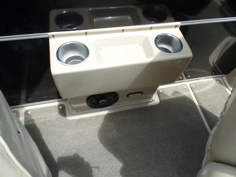 Slide: The Image of 2013 SunCatcher Elite 326 SS boat interior with cup holders and speaker. - 8