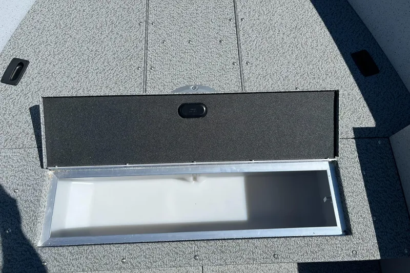 Slide: The Image of Open storage compartment on 2025 Lund 1600 Fury Tiller boat. - 11