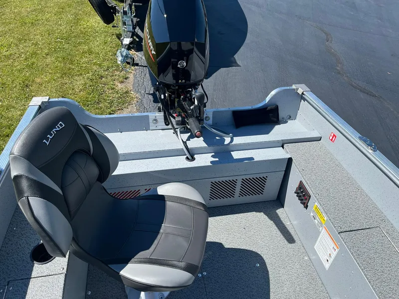Slide: The Image of 2025 Lund 1600 Fury Tiller boat interior with motor and seat. - 13