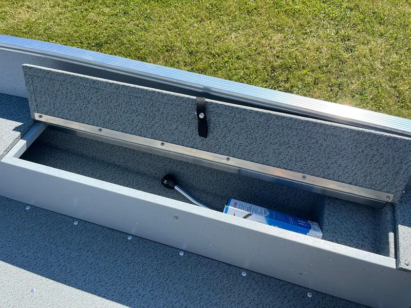 Slide: The Image of Storage compartment of 2025 Lund 1600 Fury Tiller boat with a tool and box. - 16