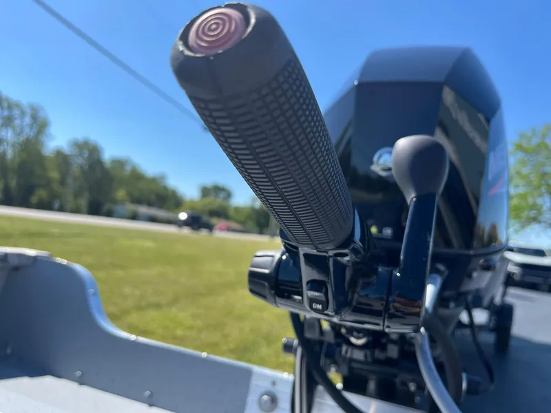 Slide: The Image of Close-up of the tiller handle on a 2025 Lund 1600 Fury Tiller boat. - 17