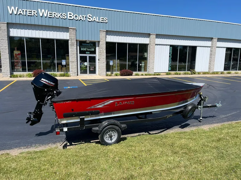 Slide: The Image of 2025 Lund 1600 Fury Tiller boat on trailer outside Water Werks Boat Sales. - 5