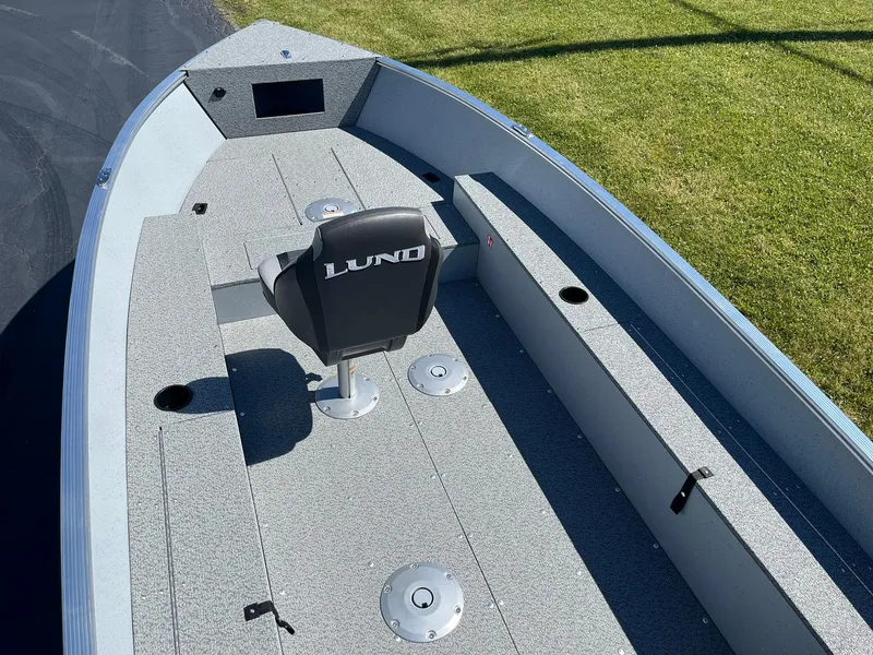 Slide: The Image of 2025 Lund 1600 Fury Tiller boat interior with single seat and storage compartments. - 7
