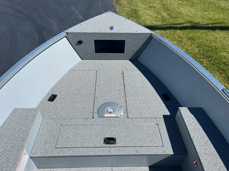 Slide: The Image of 2025 Lund 1600 Fury Tiller boat interior with storage compartments and seating. - 9